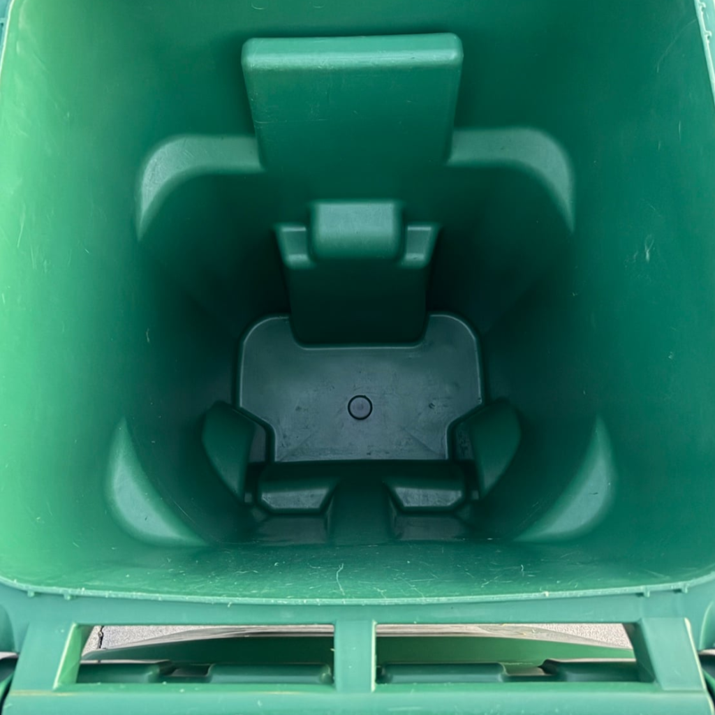 The same green compost bin interior after a RinseRight wash