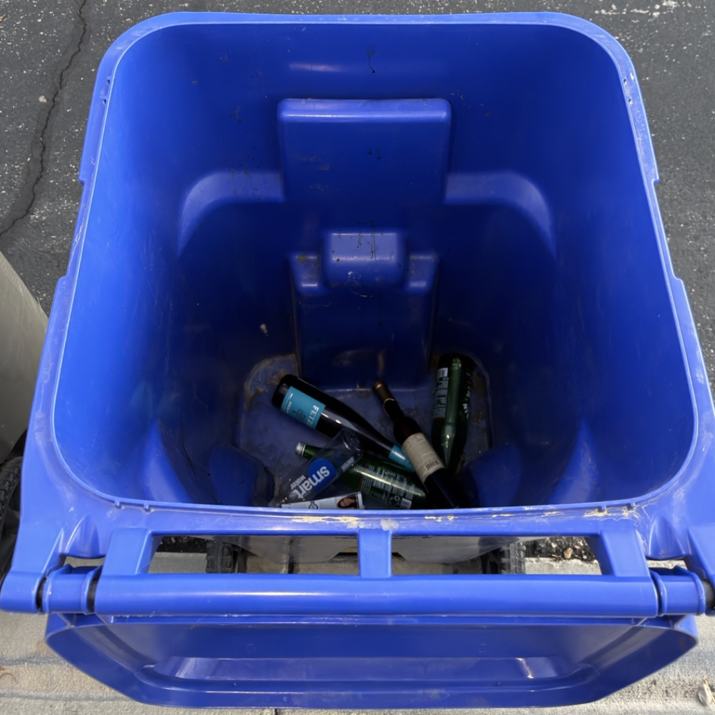 A heavily stained trash bin interior before a tough cleanup